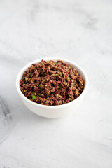Homemade Mixed Olive Tapenade in a Bowl, side view.