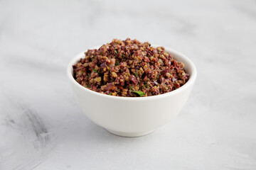 Homemade Mixed Olive Tapenade in a Bowl, side view.