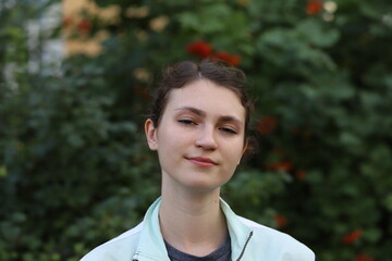 portrait of a cute girl on a background of trees