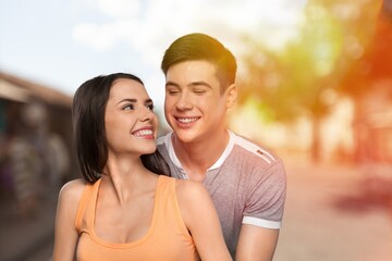 Naklejka premium Happy young couple have fun on street background