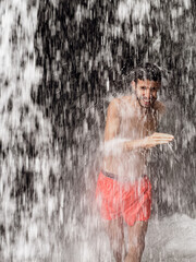 Man standing under a waterfall
