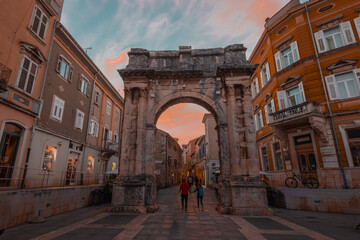 Arc de triomph in Pula, croatia. Evening hours with late afternoon sky. Famous monument in the biggest city of Istria.