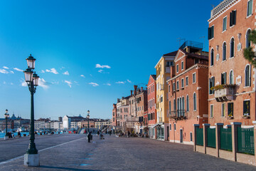 Fototapeta na wymiar The Riva Degli Schiavoni was built in the 19th century and it is a promenade that sits on the waterfront at St. Mark's Basin and main pedestrian street, often overcrowded of tourists in Venice. 2019