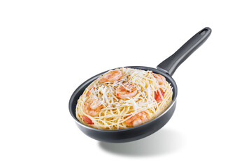 Shrimp pasta with tomatoes and cheese in a black pan on a white isolated background