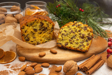 Traditional Christmas cake with raisins and fruits on wooden and white background. Traditional sweet fruit loaf.  