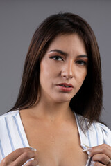 face of beautiful and sensual young latin woman with black hair wearing natural makeup, beauty in studio , person portrait