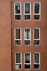 residential apartment with windows and brick wall, background with details of architecture decoration, texture and geometric figures on the facade