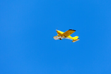 Yellow airplane. Transportation.Blue Sky.
