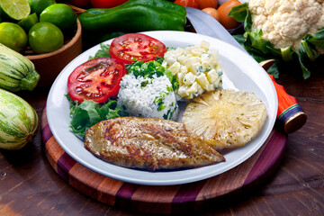 Grilled pork with fries and vegetables