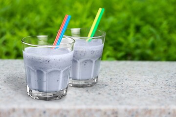 Tasty sweet milk smoothie with berry on the table