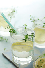Glasses with lemon and thyme refreshing drink	