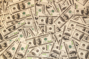 Many hundred dollar bills on the table. One hundred US dollar bills background. U.S. dollars. Banking and finance signs. Much money background. Top view. Close-up