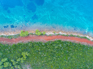 A beautiful beach from above, a meeting of colors and shapes from drone view