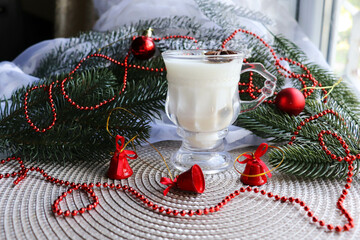 christmas card. natural soy wax candle in a glass and fir branches