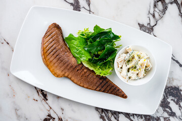Beef tongue with sauce and herbs. A dish from the chef for serving in a restaurant.