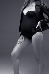 pregnancy model posing in studio, black and white photo