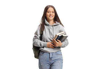 Female student carrying books and walking towards camera