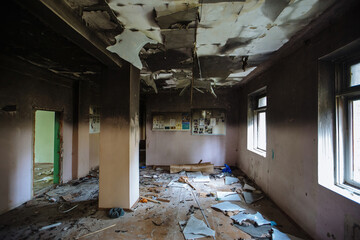 Burnt school interior. Charred walls in black soot. Consequences of fire or war