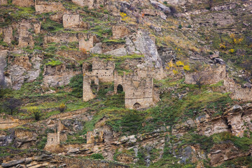 Fototapeta na wymiar Old stone town Kakhib, Dagestan, Russia. Ancient towers, ruins and houses on the rocks. Panoramic view of the city on the mountains