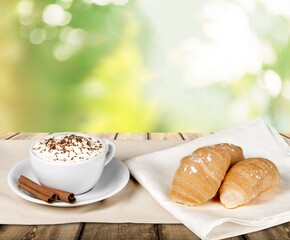 Cup of fresh aroma coffee and pastry on table