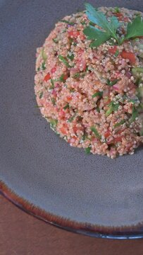 Vertical video of traditional Turkish food. Kiss in plate on the table. Middle Eastern food concept. Vertical tabbouleh video.
