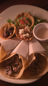 Warm video of three tasty doner kebabs filled with meat. Arabic tacos concept. Vertical video of arabic food in mexico