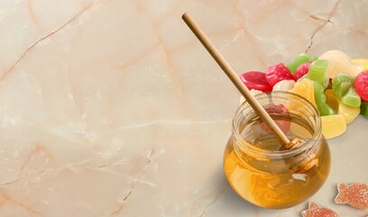Tasty sweet candy sand a jar of honey or oil