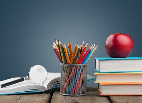 Magnifying glass with books for reading and searching information