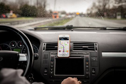 BORDEAUX, FRANCE - FEBRUARY 20, 2022: Selective blur on a smartphone using the phone app Waze on the control panel of a car, used for GPS Navigation and orientation in a car....