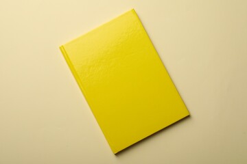 New yellow planner on beige background, top view
