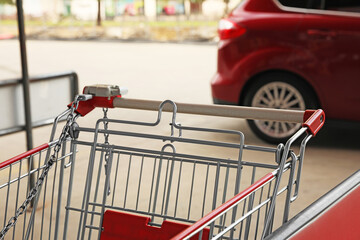 New empty metal shopping cart outdoors, closeup