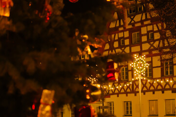 Christmas time .half timbered houses and glowing decorations.Shining garlands of European Christmas streets.Dark background with shimmering golden garlands.
