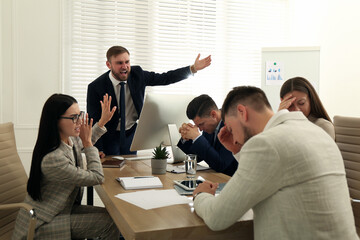 Boss screaming at employees on meeting in office. Toxic work environment
