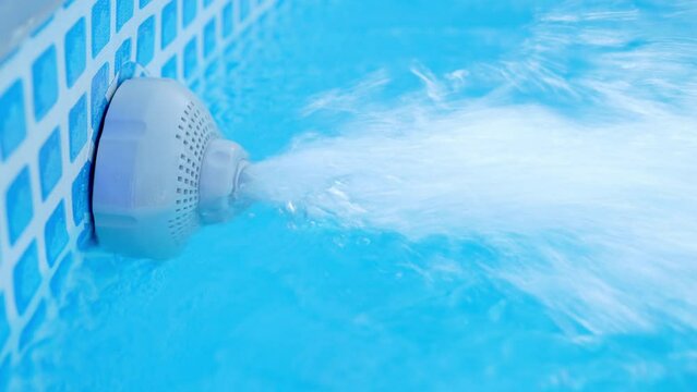 Working of underwater discharge nozzle filtration system. Transparent water movement from filtration in swimming pool.