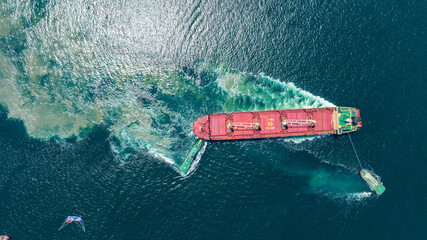 Tug Boat drag Barge ship carry Metal steel pipe construction unit , No International Sewage sludge Pollution Prevention Certificate, Sewage Sludge in the sea made by Activity of ship concept