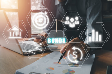 Bond Finance Banking Technology concept, Businessman using laptop computer and smartphone with bond icon on virtual screen, Trade Market Network.