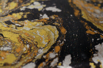 Macro shot of golden, bronze and silver particles