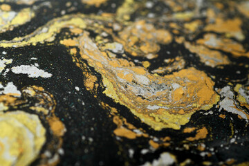 Macro shot of golden, bronze and silver particles