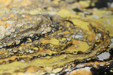 Macro shot of golden, bronze and silver particles