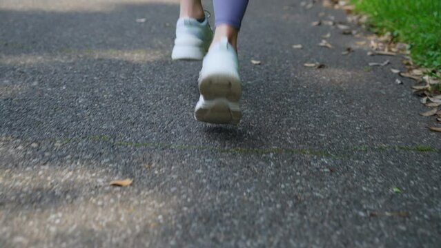 Asian woman running in the park.