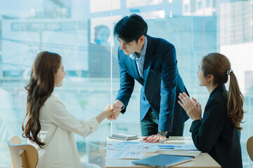 congratulations Success and Celebrate Business Ideas Business Event Conference Young Asian business men and women shaking hands at a meeting in a modern office.