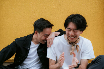 笑顔で肩を組む二人のゲイの男性