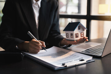 Real estate broker agent presenting form agreement, home model,