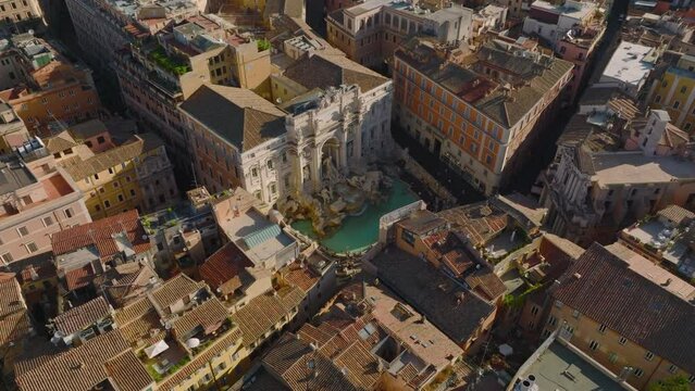 High angle view of famous Trevi Fountain with sculptures and turquoise water. Aerial view of tourist sight. Rome, Italy