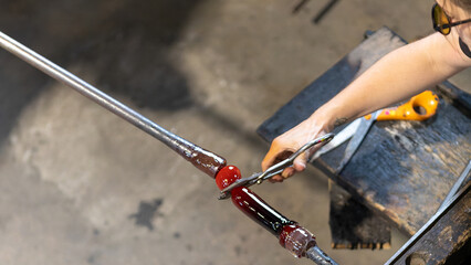 Glassblower at work in the Meisenthal's glassware in September 2022