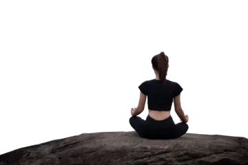  The back of a woman wearing sportswear doing a yoga pose on the rocks. © 2D_Jungle