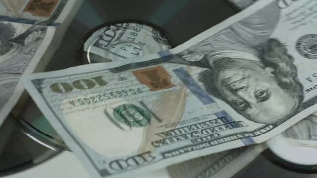 100 Dollar Bills and CDs Slowly Rotate On White Background 4K