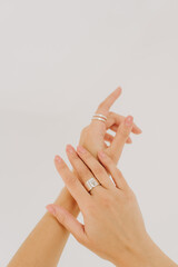 Hands of beautiful woman wearing stylish jewellery. Copy space. Female hands with silver ring. Trendy accessories