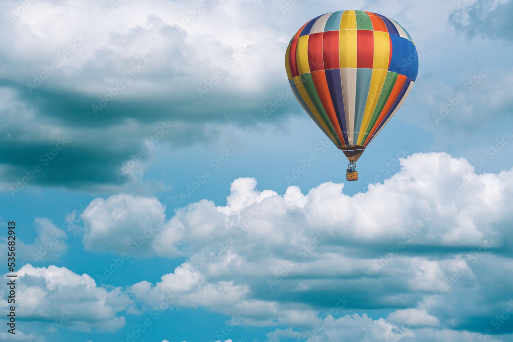 Wall mural hot air balloon in the sky, big white clouds on the blue sky, nimbostratus clouds, an altostratus cl