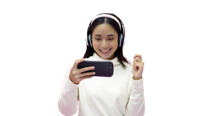 Asian women smiling and listening and singing the music with headphones on a pink studio background